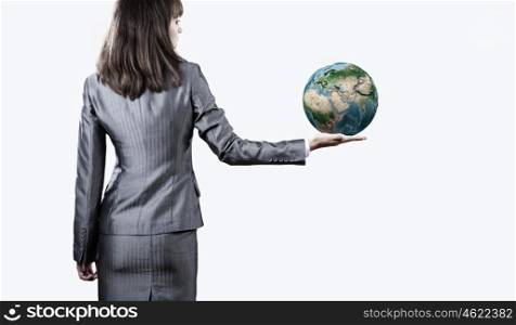 Protect our planet. Businesswoman holding Earth planet in palm. Elements of this image are furnished by NASA