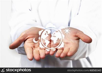 Protect our world. Close up of hands with white Earth planet figure