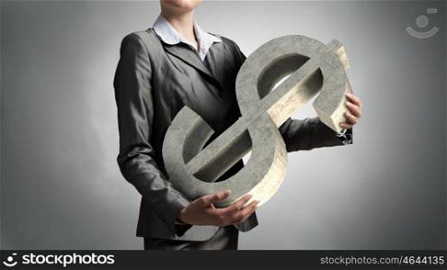 Protect your investments. Close up of businesswoman holding dollar sign in hands