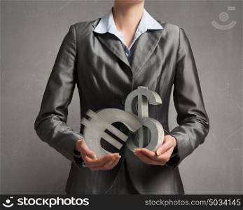 Protect your investments. Close up of businesswoman holding dollar sign in hands