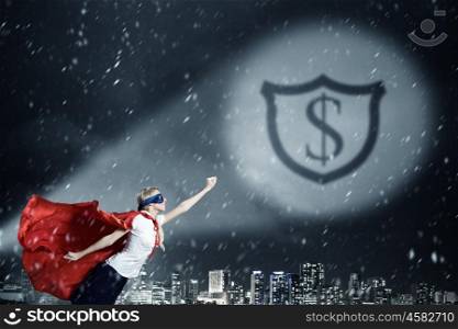Protect your savings. Young woman super hero and dollar sign in spotlight