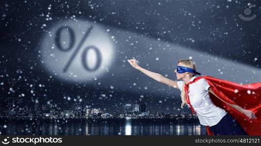 Protect your savings. Young woman super hero and interest sign in spotlight