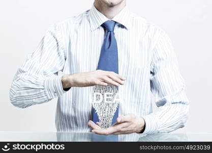 Protect your success ideas. Hands of businessman holding with care idea concept