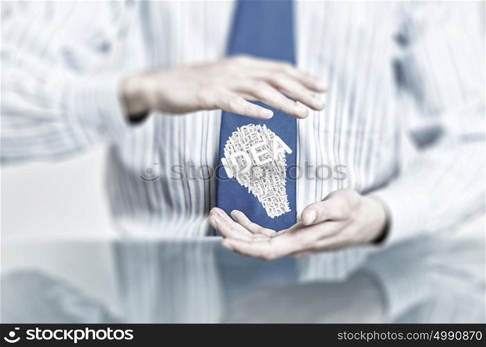 Protect your success ideas. Hands of businessman holding with care idea concept