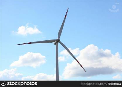 Protection of nature. Wind turbine eco power generator for renewable energy production. Alternative green clean energy, ecology. Cloudy blue sky .