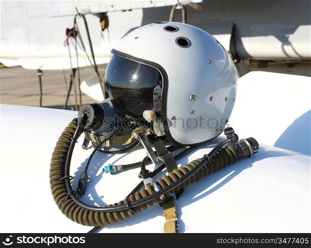 Protective helmet of the pilot against the plane with an oxygen mask on a fuel tank