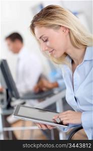 Protrait of office worker using electronic tablet