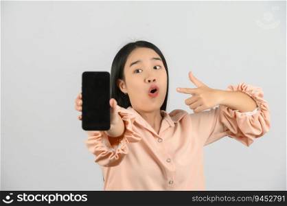 Protrait of Young asian woman expressing surprise while using mobile phone isolated over white background. Technology concept.