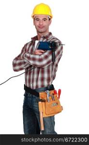 Proud tradesman posing with his electric screwdriver