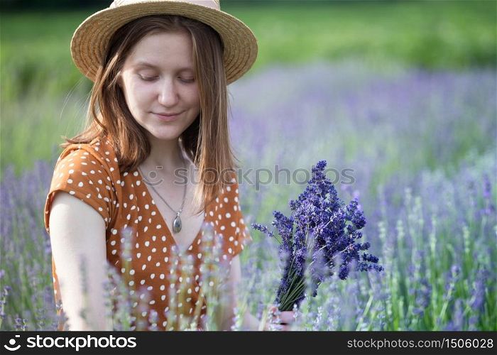 Provence - girl in a hat collects a bouquet of lavender. France
