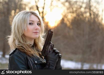 Provocative young woman at sunset in winter forest