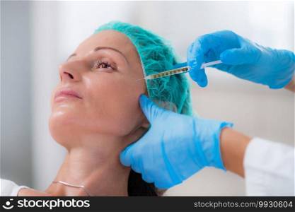 PRP Face Injection. Mid aged Woman Receives Platelet Rich Plasma Face Injection for Reduction of Skin Wrinkles. PRP Face Injection in Platelet Rich Plasma Aesthetic Medicine Treatment