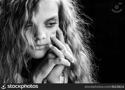 Psychological black and white portrait of a girl on a black background
