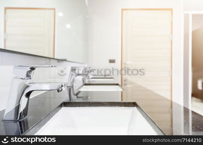 public Interior of bathroom with sink basin faucet lined up Modern design.