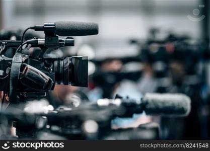 Public live event media coverage, television cameras at a press conference. Public Live Event Television Coverage