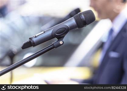 Public speaker giving a speech at business conference, presentation or media event