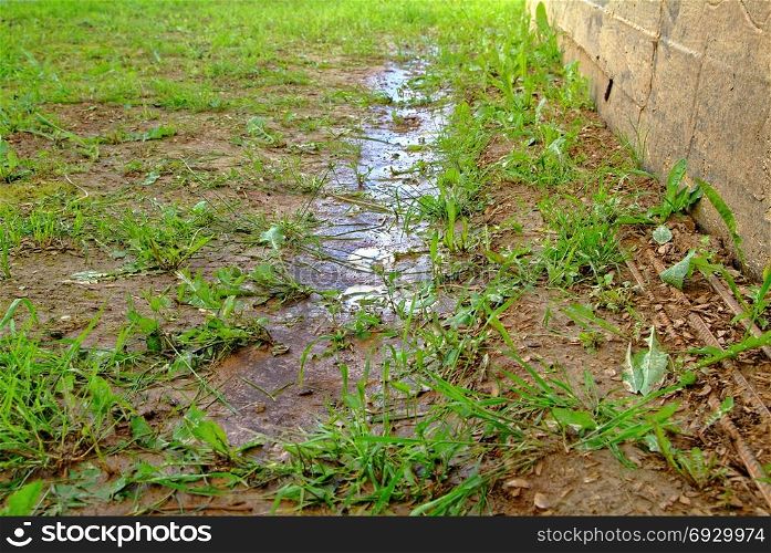 puddles after rain near the wall of a wooden house. puddles after rain near the wall of a wooden house, Russia