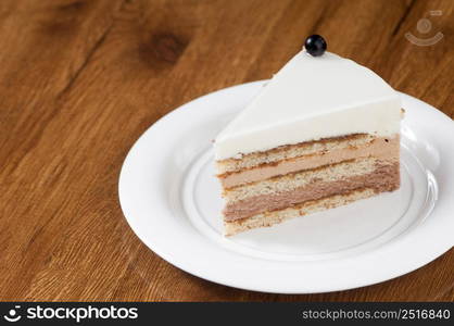 puff pastry in a round white plate on a wooden surface with reflection. ice cream on round plate