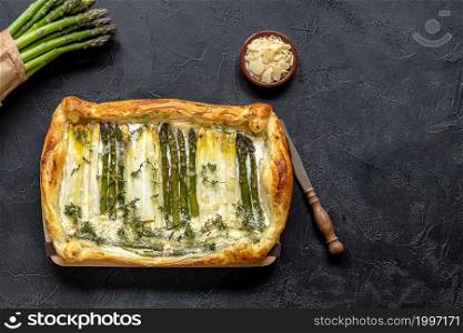 Puff pastry tart with green and white asparagus and parmesan cheese. Healthy food. Top view.