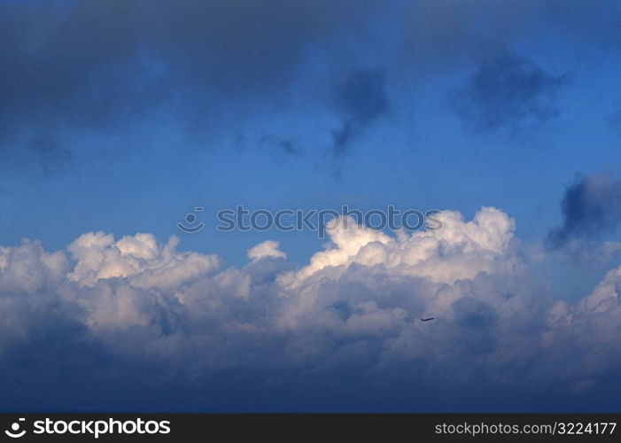 Puffy White Clouds In A Light And Dark Blue Sky