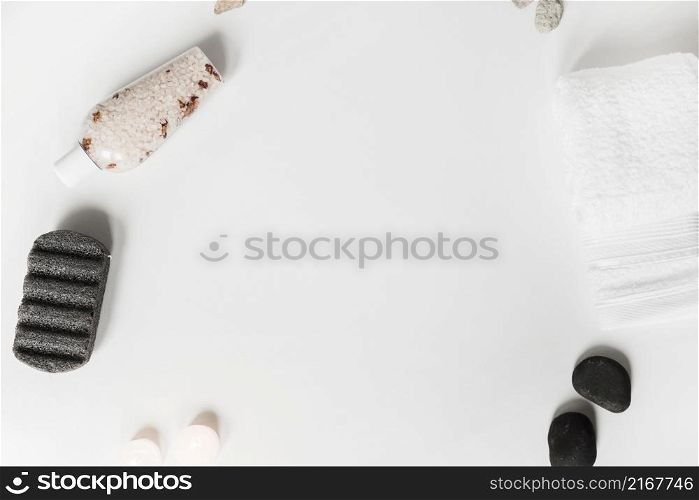 pumice stone herbal salt spa stone candles towel white background