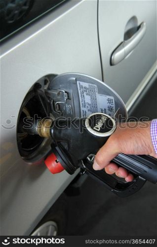 Pumping gas at a self service gas station
