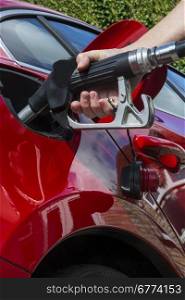 Pumping Gas - Filling a cars fuel tank with diesel or petroleum.
