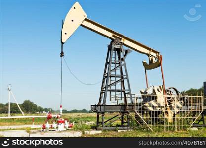 pumpjack pumps oil in Kuban region, Russia in summer day