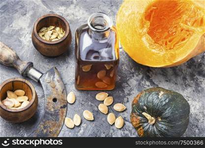 Pumpkin and healthy pumpkin seed oil.Autumn food. Bottle of pumpkin oil