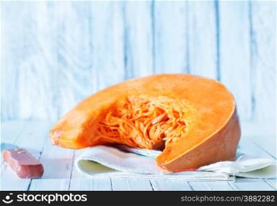pumpkin and knife on the white table