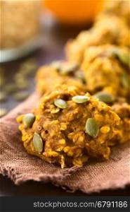 Pumpkin and oatmeal drop cookies with pumpkin seeds on top, photographed with natural light (Selective Focus, Focus one third into the image)