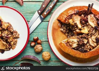Pumpkin baked with granola and dried fruits.Autumn dessert.American food. Pumpkin stuffed with dried fruits