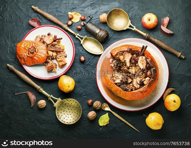 Pumpkin baked with granola and dried fruits.Autumn dessert.American food. Pumpkin stuffed with dried fruits