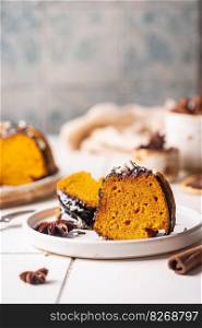 Pumpkin bundt cake with chocolate glaze and nuts on top, top view. Pumpkin bundt cake