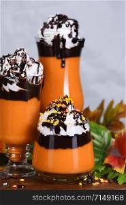 Pumpkin chocolate beverage with whipped cream and chocolate topping
