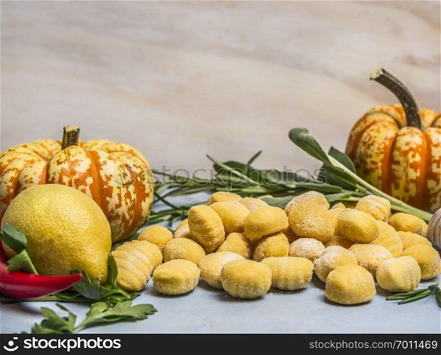 pumpkin gnocchi with pumpkin pepper lemon herbs  on blue wooden background close up