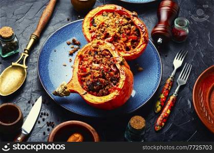 Pumpkin halves stuffed with minced meat,vegetables and quinoa.Autumn stewed pumpkin hokkaido. Roasted pumpkin with minced meat and quinoa