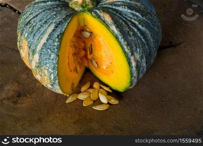 Pumpkin is a fresh vegetable have a green and yellow color on a wooden table