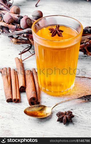 pumpkin jelly drink with anise in the background with wreath of fir cones in autumn. pumpkin jelly drink