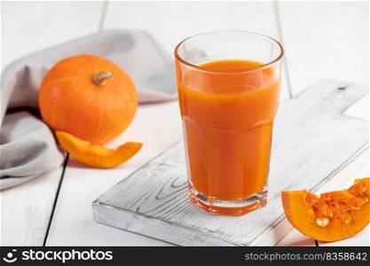 Pumpkin juice in a glass on white background. Detox vegetable drink. Healthy vegan food. Diet concept.. Pumpkin juice in glass on white background. Detox vegetable drink. Healthy vegan food. Diet concept.