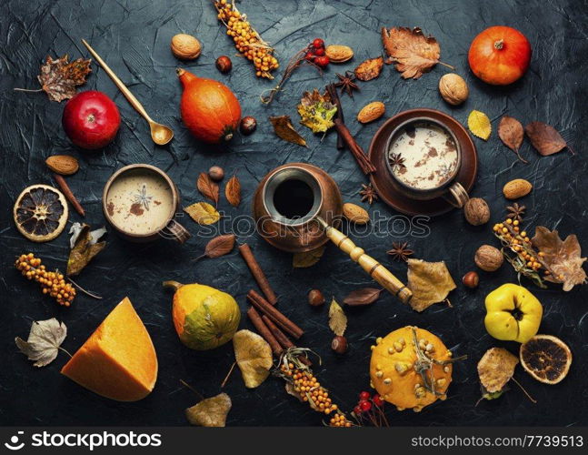 Pumpkin latte or coffee on an autumn background. Delicious pumpkin latte