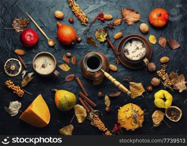Pumpkin latte or coffee on an autumn background. Delicious pumpkin latte