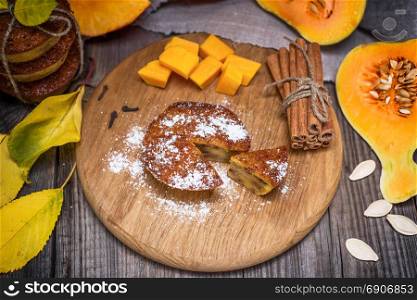 pumpkin muffins and fresh pumpkin slices, top view