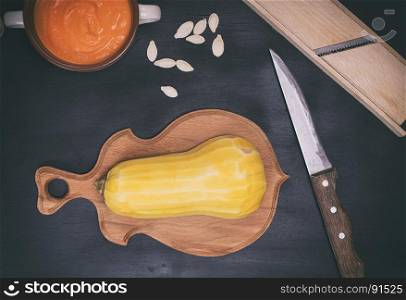 pumpkin on brown cutting board, top view