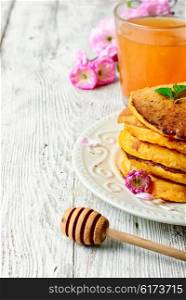 pumpkin pancakes with light dishes and glass of juice. fritter with pumpkin