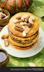Pumpkin pancakes with maple syrup and nuts. Pancakes with maple syrup.
