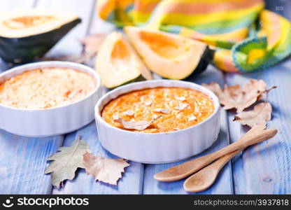 pumpkin pie in bowl and on a table