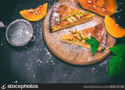 pumpkin pie on a wooden board, top view