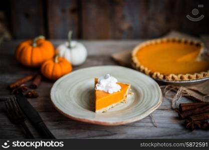 Pumpkin pie on rustic wooden background