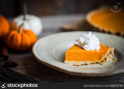 Pumpkin pie on rustic wooden background